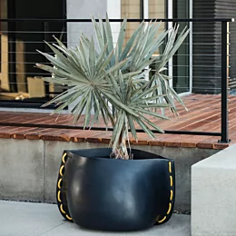 Blinde Design Stitch 75 Planter frames the Starfire garden with sleek graphite concrete for durable modern outdoor appeal.